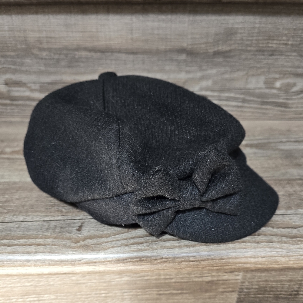 Manhattan Hat Co. black wool cap with decorative bow.